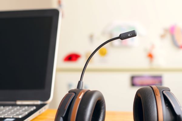 A headset next to a computer