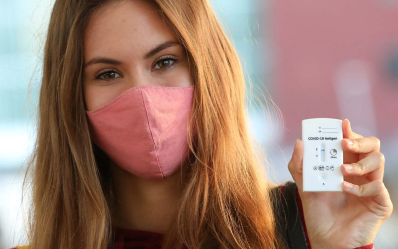 Young woman wearing a pink facemask