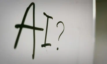 AI stock image - photo of AI written on whiteboard with question mark after it