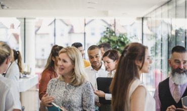 Business professionals attending business conference, networking, busy, discussion, collaboration