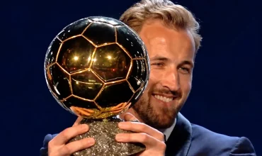 Harry Kane holding up Ballon d'Or trophy after winning in 2026 ceremony