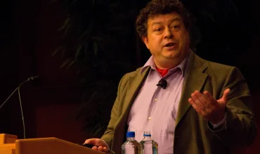 Rory Sutherland speaking at event on stage