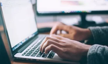 Person typing at a computer